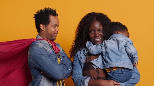 Happy Family Posing with Superhero Dad