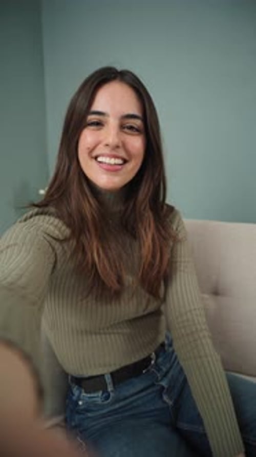 Smiling Woman Waving During Video Chat at Home