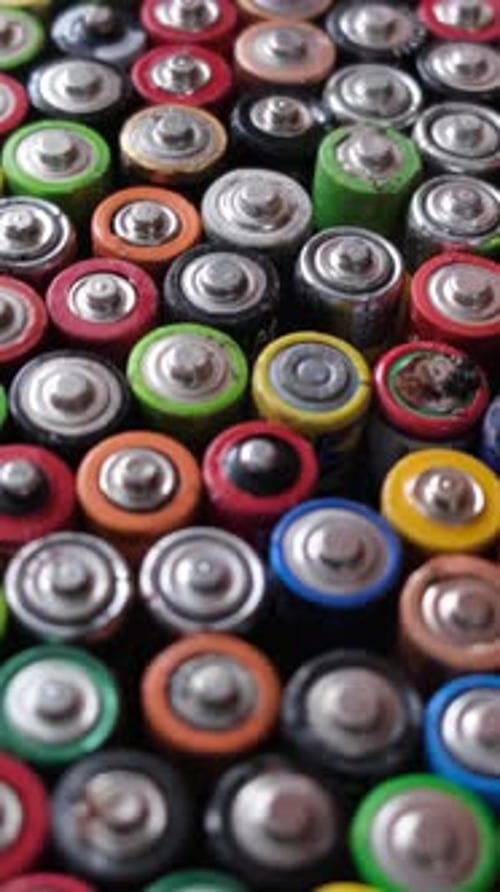 Pile of Used Colorful Batteries Close Up