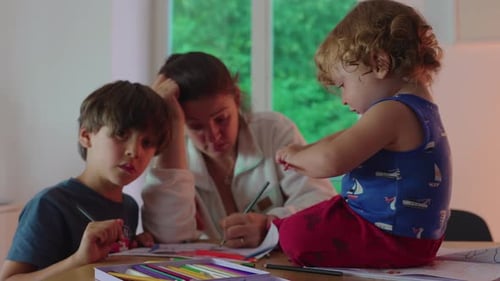 Woman and Children Drawing with Colored Pencils at Table