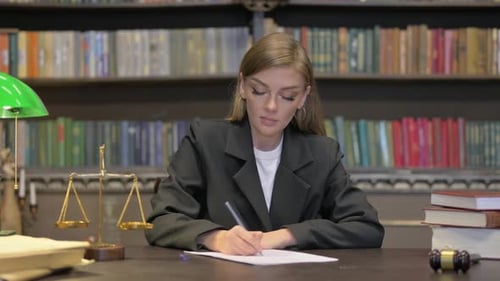 Female Judge Writing Verdict in Office