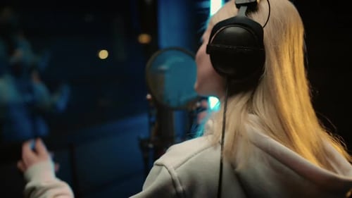 Blonde Woman Singing in Professional Recording Studio Voice Acting and Podcast Back View of Talented