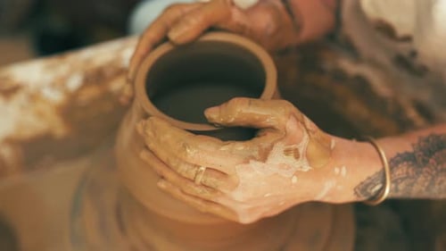 Person, hands and clay for pottery sculpture, vase or ceramics in creativity