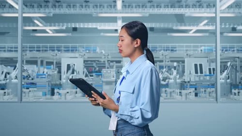 Asian Female Professional Worker Use Tablet And Look Around at Factory Digitalization
