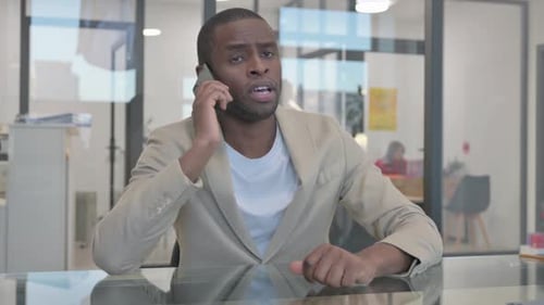 Man in Office Talking on Phone
