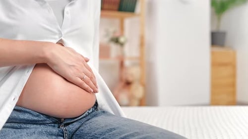 Loving Pregnant Woman Gently Strokes Her Belly