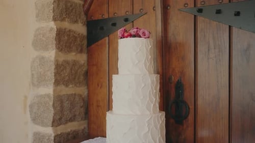 Elegant White Wedding Cake with Pink Roses Topper