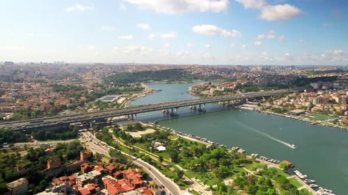 Aerial drone view of Istanbul, Turkey. Halic Bridge with multiple moving cars, multiple residential