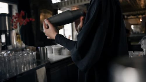 Close-up - the process of preparing a cocktail in a restaurant using a shaker
