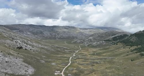 Empty Asphalt Road on the Plateau Between Green Fields Aerial View