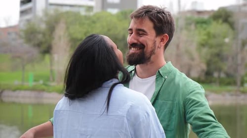 Romantic Couple Embracing near Pond in Urban Park