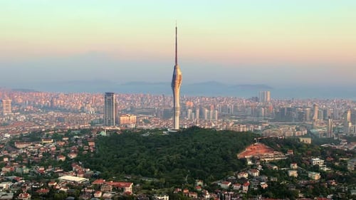 Aerial drone view of Istanbul at sunset, Turkey. Camlica Tower, greenery, cityscape on the backgroun