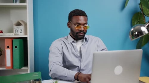 Young Adult Man Working On Computer In Office