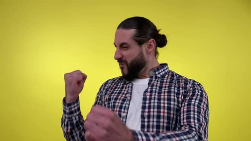 Man Smiling and Raising Arms in Triumph