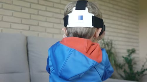 Child Experiencing Virtual Reality with Headset Indoors