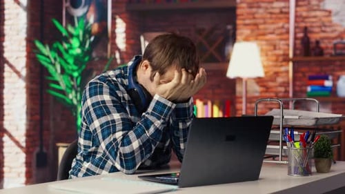 Man at Computer Experiences Frustration, Stress at Desk