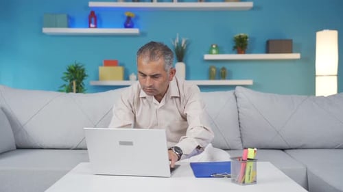 Home office worker man working on laptop.