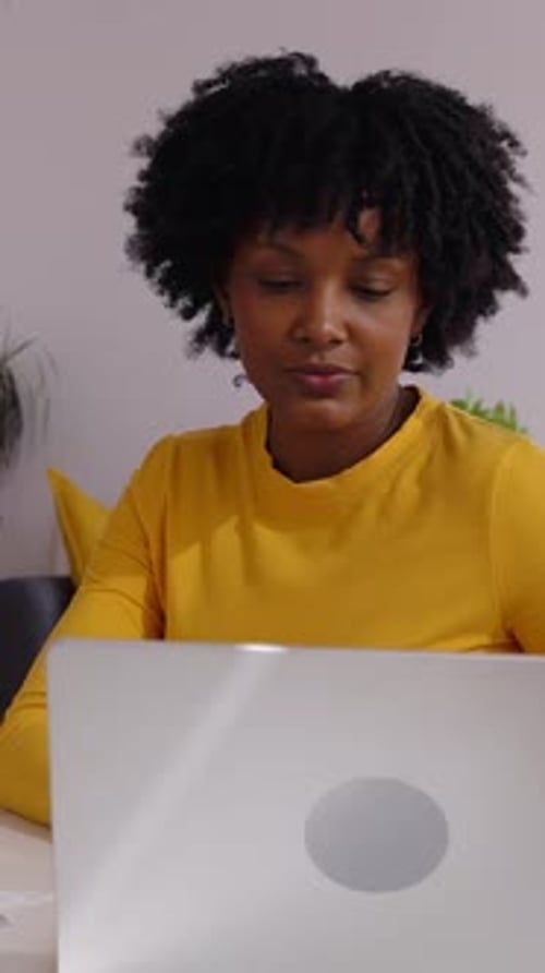 Focused Accountant Managing Invoices and Calculating Expenses at Home Office