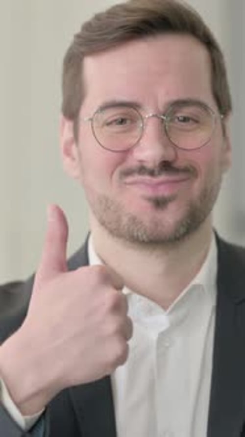 Positive Man Gives a Thumbs Up in Portrait Video