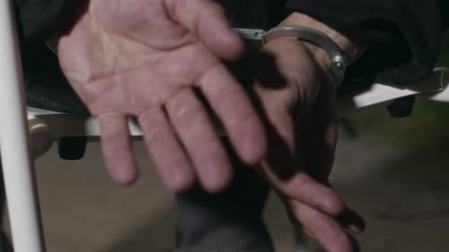 Cuffed Hands Restrained on a Chair