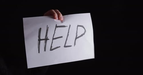 Turning Help Sign Toward Camera – Mental Health Awareness Concept