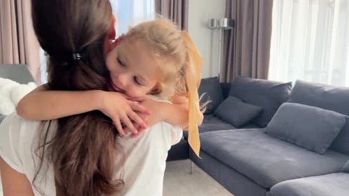 Affectionate Daughter Hugging Mother in Living Room
