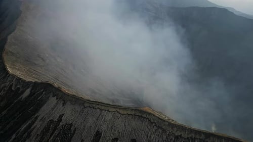 Man Walking Cliff Volcano Crater Drone View