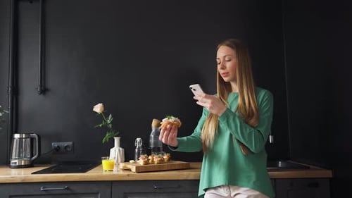 Woman Taking Food Photo in Modern Kitchen