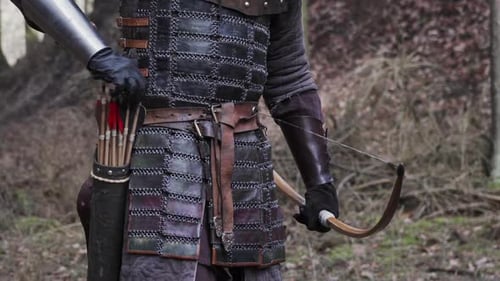 Medieval archer draws arrow and shooting bow, middle age concept