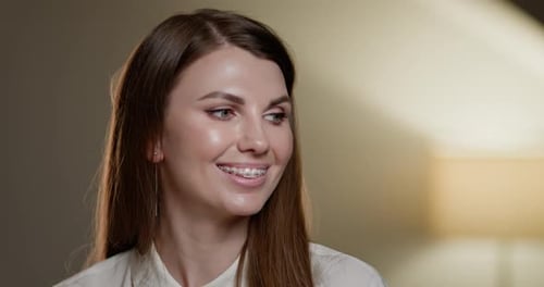 Smiling Woman with Braces Looks to Side