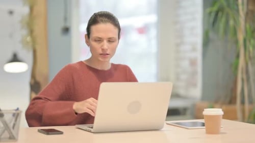 Woman Has Back Pain While Working at Computer