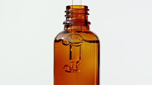 Close-Up of Liquid Being Added to Brown Bottle