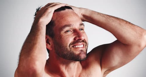 Clean, man and happy with wet hair in studio for shampoo shine, morning routine and grooming