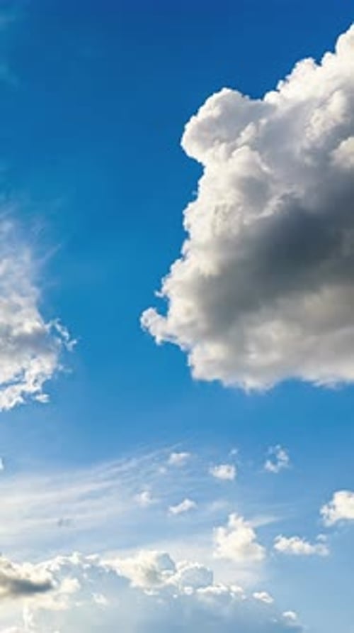 Large White Cumulus Cloud Against Deep Blue Sky