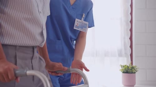 Healthcare Worker Helping Senior Man with Walker