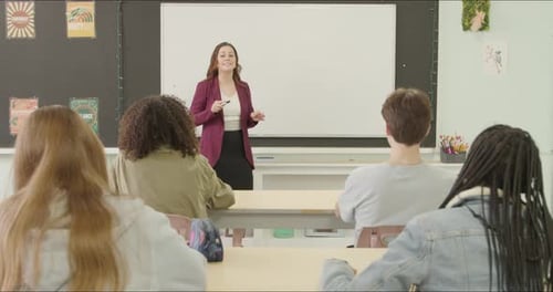 Students Learning in School Class Room. High School or College Class Raising Hand Asking Questions