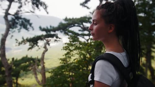 Adventure Trip Young Woman Hiker with Dreadlocks Looking Around in the Forest