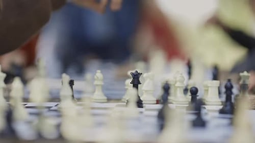 A Hand of Teen Boy Plays Chess in Park