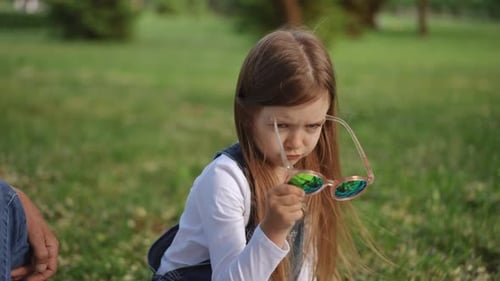 A Father and His Daughter Enjoying Quality Time Together in the Park on a Sunny Day