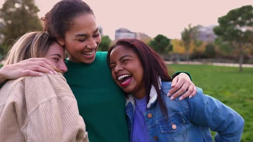 Three Attractive Women Laughing Together Outdoors