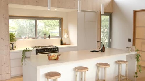 Modern Kitchen Interior with Island and Wooden Stools