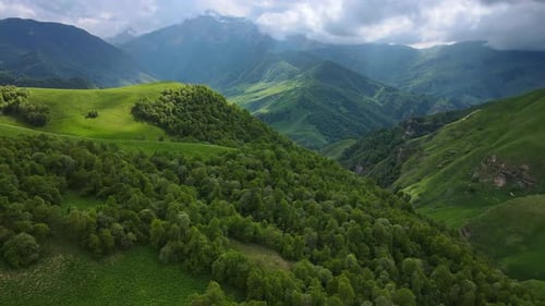 An Aerial Perspective of a Verdant Valley Embraced By Towering Mountains