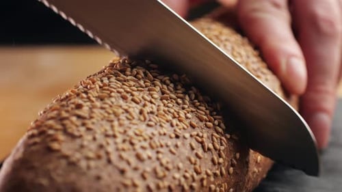 Slicing Sesame Bread with Sharp Knife