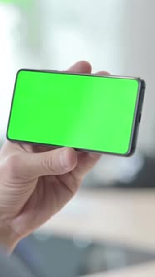 Man Holding Horizontal Smartphone Chroma Key Green Screen, vertical video