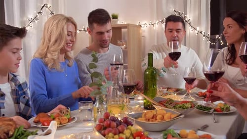 Family and Friends Toasting Wine at Festive Dinner