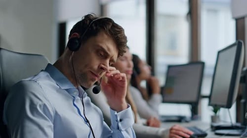 Serious Agent Talking Headset in Customer Support Office Closeup Tired Man Work