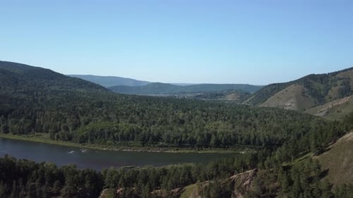 Awesome aerial view of scenic river among evergreen woods