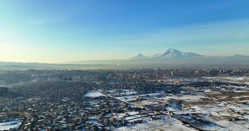 Aerial view A snowy Yerevan Armenia cityscape with a few houses and a few cars