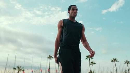 Man Stretching Before a Run on the Beach