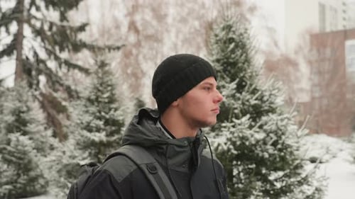 Student Observing Snowcovered Campus Young Man Dressed for Winter Exploring Campus Pathways Casual